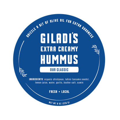 Label of Giladi's Extra Creamy Hummus with ingredients listed and instructions to drizzle olive oil for extra goodness.